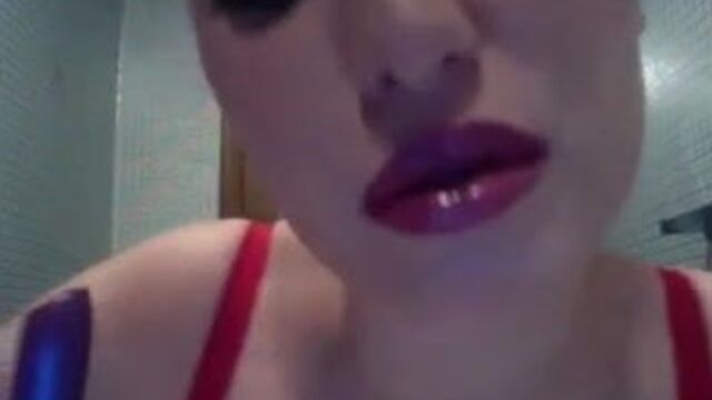 Sexy woman putting on lipstick